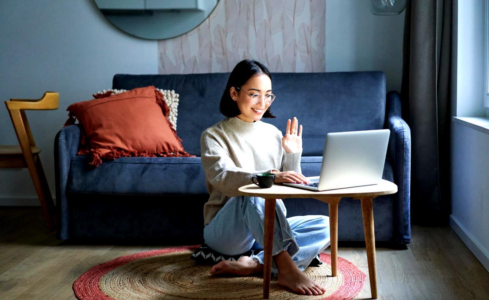 Business meeting with financial documents and laptop showing data analysis results